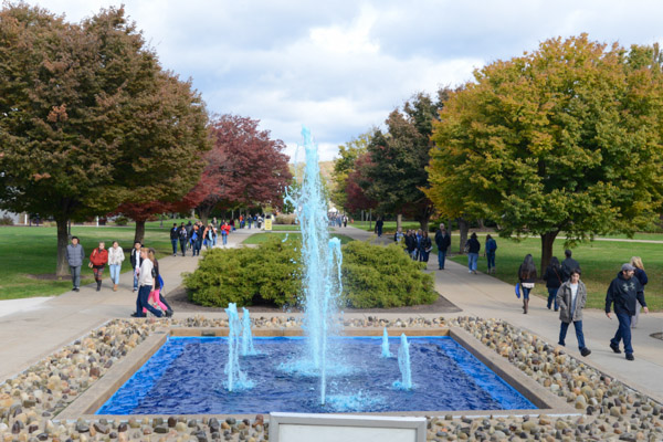 A Wildcat-blue fountain, a remnant of the spirited midmonth Homecoming Weekend, is the centerpiece of a busy campus crossroads.