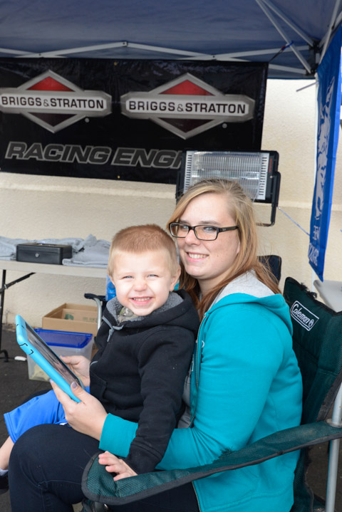 Amanda A. Golder, a first-year automated manufacturing technology student, volunteers at the Society of Manufacturing Engineers’ mini Baja booth with helpful son Jaydon ... 
