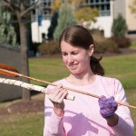 Melissa L. Warner, a building science and sustainable design major from Stroudsburg, readies the atlatl that she made as part of Cooley's Introduction to Cultural Anthropology class.