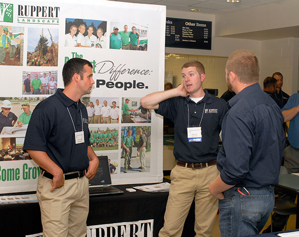 Returning to his alma mater, Wesley J. Fouse (center) – an ornamental horticulture alumnus – staffs a booth for the Maryland--based Ruppert Landscape. The 2009 graduate talks with co-worker Jack Hendrickson and Justin Shelinski, laboratory assistant for horticulture.