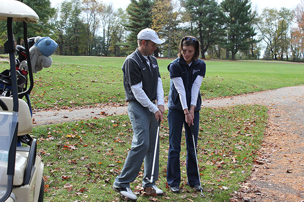 Becky J. Shaner, alumni relations specialist, picks up some Hall of Fame pointers from alumni/employee/Wildcat golf coach Matthew R. Haile.