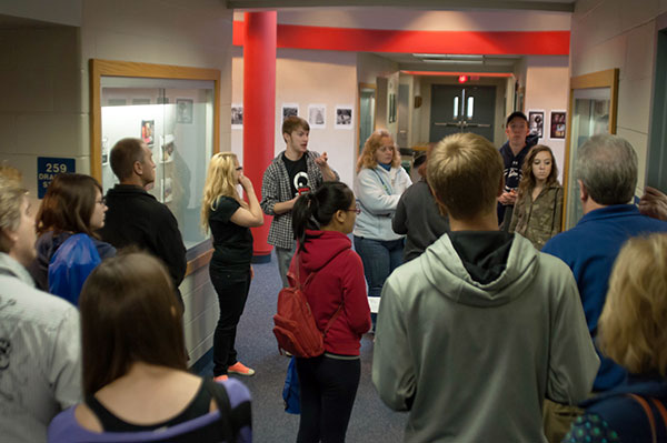 Zachary G. Bird, a graphic design student from South Williamsport (center background) talks with interested guests on the second floor of the Bush Campus Center.