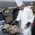 Bradley M. Moriarty, a culinary arts and systems student from Milesburg, browns beef for cheesesteak samples.
