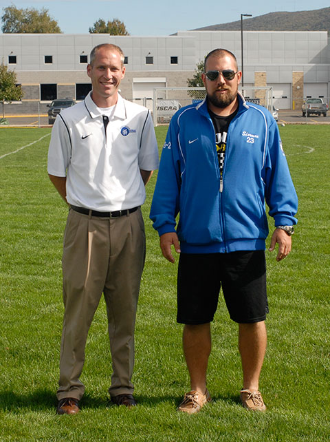 ... and joins inductee Adam N. Waigand (right) a 2005 graduate and former Wildcat soccer defender, along the sidelines the following afternoon.