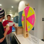 Kristi L. Hammaker, health and fitness specialist, gauges a student's mental health awareness as the question wheel stops on a category.