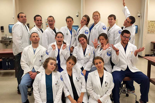 Junior physician assistant students enjoy a moment of fun after leading a workshop for Career Day participants that included the rare opportunity to hold human organs – a heart, lungs and a lower limb.