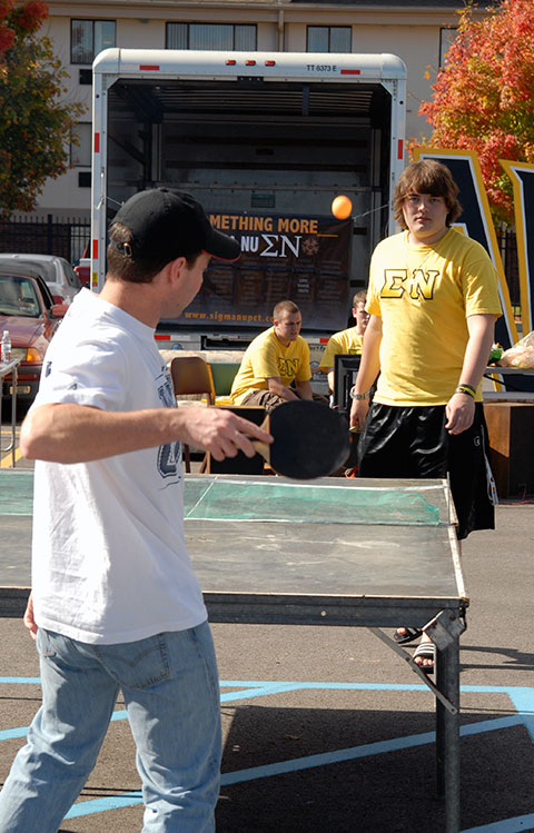 Two Sigma Nu brothers show off their pingpong prowess.