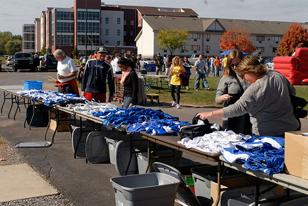 Bargain-hunters pore through jerseys and other sports apparel in a uniform sale behind the Field House.