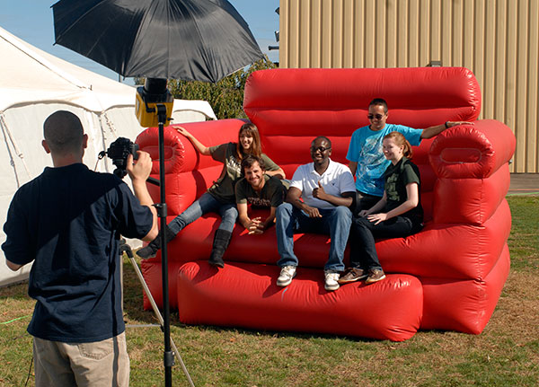 Members of the Wildcat Events Board climb aboard the oversized, inflatable chair for photo fun.