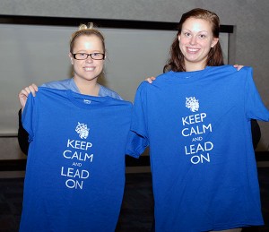 Student leaders Nicole E. Smith (left) and Megan N. Heckman show off the commemorative T-shirts given to each of the evening's graduates.