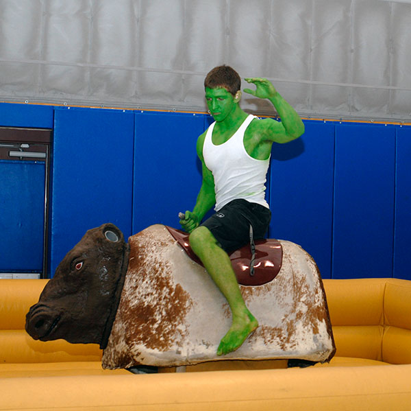 Tinted a Hulkish green for the night, RA George W. Settle III rides the mechanical bull.