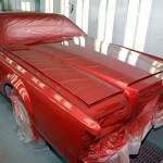 Awaiting the next step in its makeover, a repainted Lincoln catches the Monday sun while curing.
