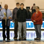Cross-country senior Edward S. Knyff joins his parents and coach David J. Mendez during Monday's Senior Night in Bardo Gym.