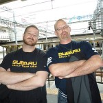 Adopting a goodnaturedly competitive stance are Penn College alumnus James S. Riedel (left) and Subaru technician Mark Jurkovski.