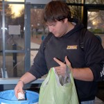 Jacob T. Cartwright, a plastics and polymer engineering technology major from Ickesburg, adds the Society of Plastics Engineers donation to the collection bin.