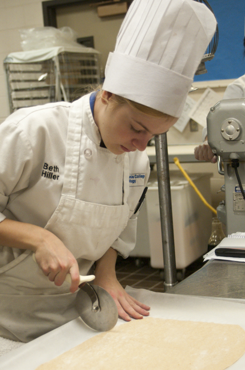 Baking and pastry arts student Elizabeth M. Hiller prepares dough for the bread course.