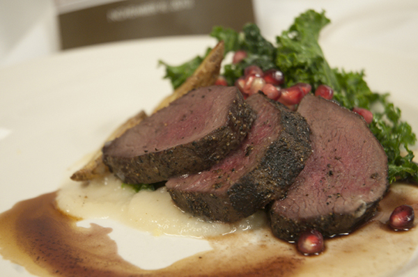 The fourth course: Venison loin with sunchoke creamed kale and pomegranate bordelaise sauce.