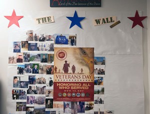 “The Wall,” an ever-growing photo collage of servicemen and women who attend or work at Penn College, as well as their family members and loved ones, is displayed in the Financial Aid Office. (Photo by Marc T. Kaylor, student photographer)