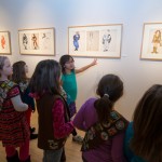 Paper dolls draw the girls' interest.