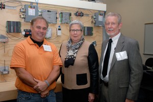 Ecosave Automation’s Jack Clift (right) celebrates a longtime Penn College partnership with faculty member Todd S. Woodling and President Davie Jane Gilmour.