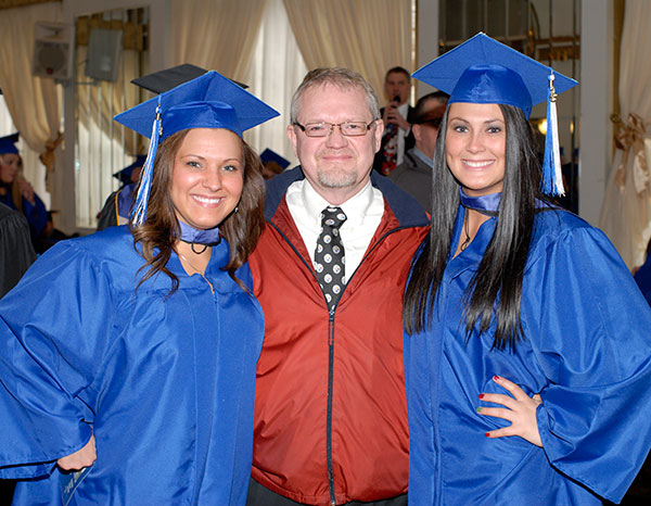 Faculty member Daniel K. Christopher poses with health information technology graduates Ashley M. Lynch, of Montgomery (left), and Tara M. Powell, of Burgettstown.