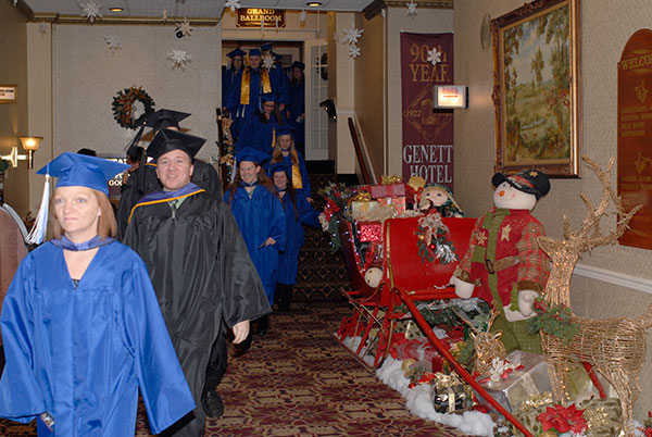 Hustling to beat the raindrops, the procession passes through the festively decorated Genetti Hotel lobby.