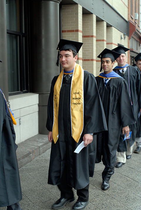 Earning a degree in technology management, Ryan M. Enders – the 2012-13 president of the Student Government Association – enters the auditorium.