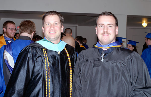 In his first commencement since returning to Penn College as assistant dean of sciences, humanities and visual communications: programs, Thomas C. Heffner (left) congratulates Jason D. Matula, a graphic communications management major from Bethlehem.