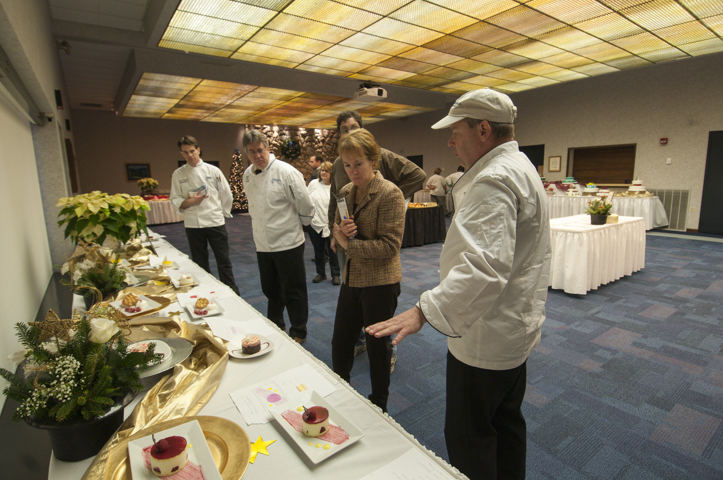 Faculty and judges, from left, Charles R. Niedermyer, instructor of baking and pastry arts and culinary arts; Frank M. Suchwala, assistant professor of hospitality management and culinary arts; Tony Sapia (partly obscured), owner of Gemelli Bakers; Elizabeth Long-Furia, owner of Elizabeth’s An American Bistro; and Michael Davis, executive chef for Susquehanna Health, deliberate over the Classical and Specialty Desserts entries.