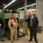 David R. Cotner, dean of industrial, computing and engineering technologies, leads educators through the Avco-Lycoming Metal Trades Center; the group also toured the Machining Technologies Center.