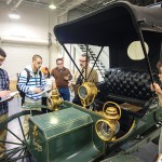 Automotive restoration technology students, with instructor Roy H. Klinger, inspect a 1907 Duryea.