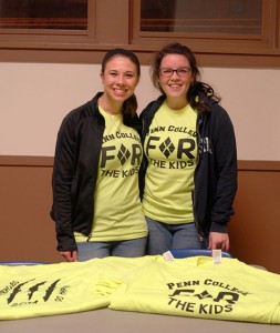 Photographed during a recent THON "Gold Out" benefit in Bardo Gym, Kelsey J. Maneval (left) and Madeline A. Lusk sell (and wear) the charity's T-shirts, while putting a friendly face to the serious battle against pediatric cancer.