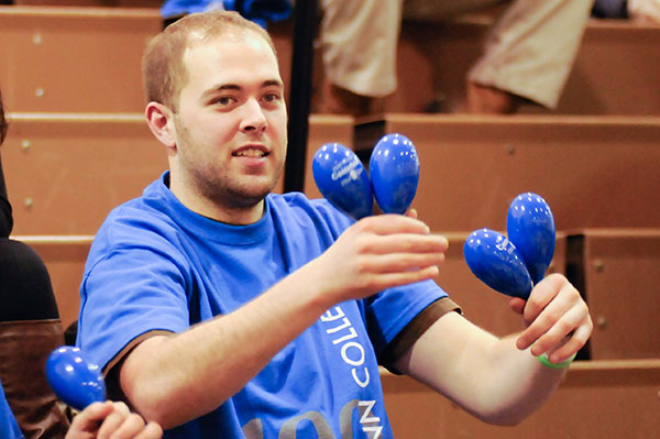 Ryan C. Hunt, a building automation technology major from Scotia, N.Y., and new vice president of the Off-Campus Housing Organization, makes some noise (and a fashion statement), thanks to the centennial T-shirt/maraca giveaway.