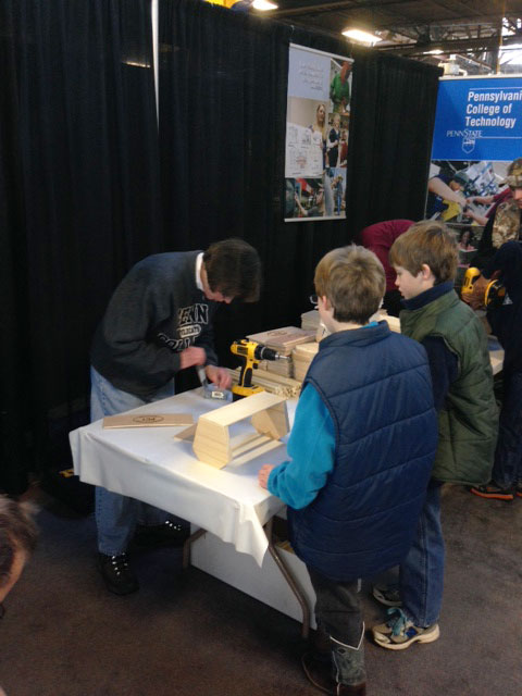 Assisting young visitors in finding just the right construction hardware is Anne K. Soucy, assistant dean of construction and design technologies.