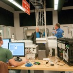 Daniel R. Mendell, right, a ShaleNET U.S. consultant/instructor, talks with Marino about a well-site simulator being set up with input from students in the electronics and computer engineering technology major. Seated is Patrick J. Reid, who is developing programmable logic controls for the simulator as part of his senior project.