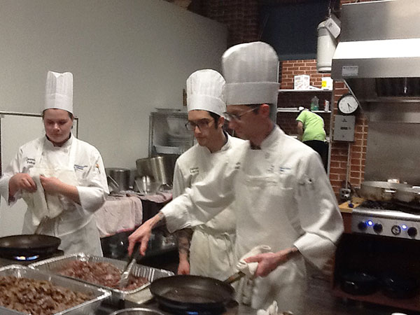 From left, culinary students Jessica N. Felton, of State College; Darren J. Layre, of Hatboro; and Patrick J. Kelly II, of Cogan Station; prepare some of the opening weekend's 6,000-plus servings.