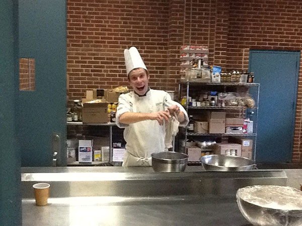 It's not all drudgery in the kitchen, as Wyatt F. Fink, a culinary arts and systems student from Cogan Station, playfully proves during Farm Show prep.
