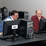 Walter J. Shultz, OIT director (left) assists Lawrence K. Beaston, assistant professor of English-composition.