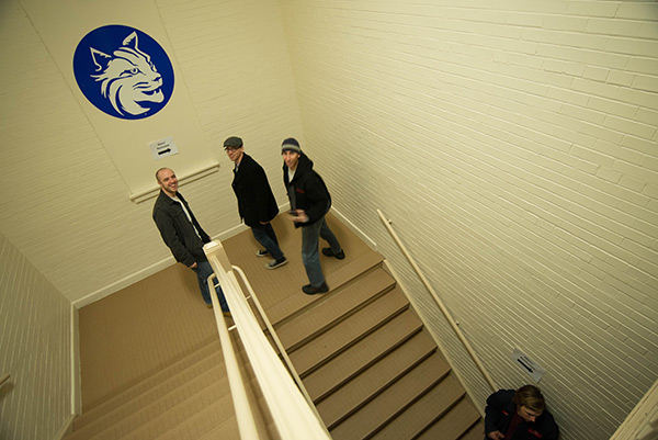 Excited about the show, students ascend the gym's stairway.