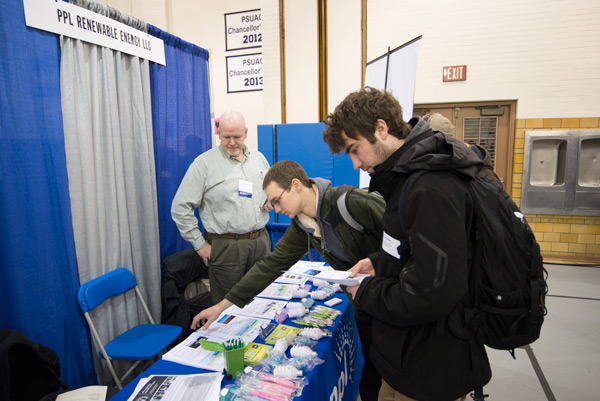 Students visit a PPL Renewable Energy table staffed by Thomas W. Judge, a 1984 diesel mechanics alumnus.