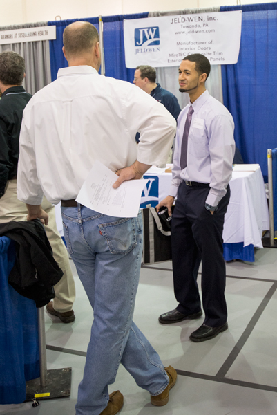 Student Hector A. Alvarez Jr., a residential construction technology and management major, gets acquainted with Mike Cahill of Keystone Custom Homes.