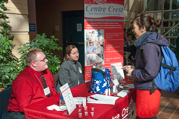 Centre Crest representatives Zachary Robinson and Dana Keeler chat with a student.