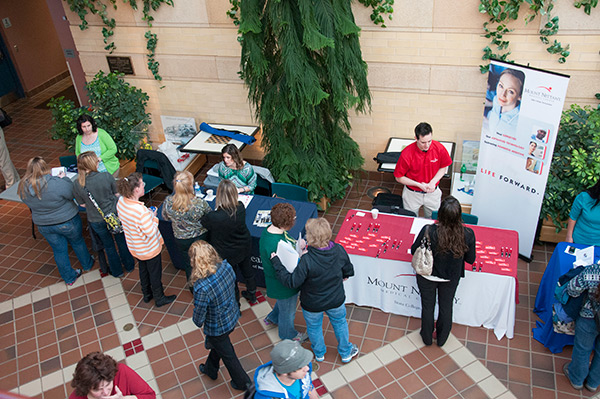 Students talk with recruiters from a variety of health care organizations in the ATHS lobby.
