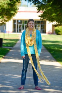 Elaina G. Stone, a general studies student from Williamsport, stands on the campus mall, adorned in a hand-knit "candy corn" scarf, in this photo from the One College Family blog.