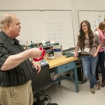 In the additive manufacturing lab, Eric K. Albert, associate professor of machine tool technology/automated manufacturing, shows the group a grip he made for carrying grocery bags.