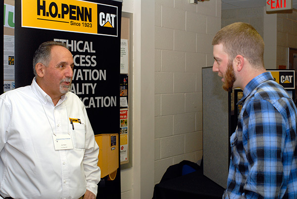 Carl Bisesi, of H.O. Penn Machinery Inc., among Penn College's supportive Caterpillar connections, gives one-on-one attention to a student.