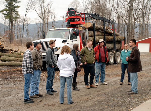 Laurie A. Nau, a 2011 graduate in forest technology, and Erich R. Doebler, laboratory assistant for forest technology, lead a tour group at the ESC sawmill.