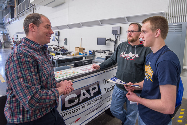 Automotive instructor Christopher A. Trapani, among the faculty for the new Mopar CAP major, lends an attentive ear.