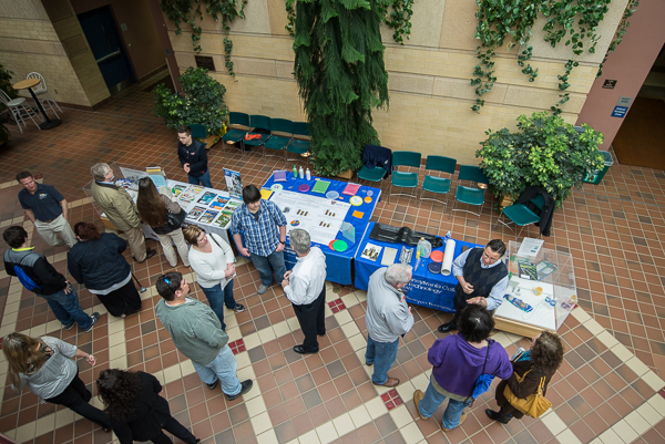 Members of the plastics faculty field inquiries in the ATHS atrium.