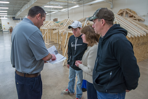Garret L. Graff, assistant professor of building construction technology, discusses required courses with a prospective student and his family.